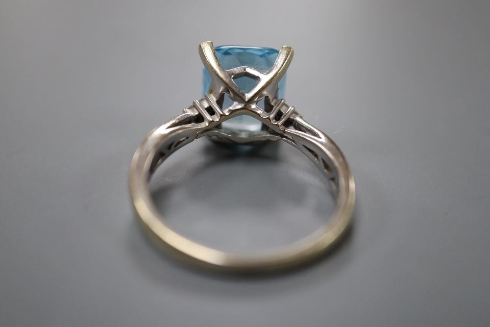 A modern 18ct white gold, blue topaz and diamond set dress ring, size S, gross 6.2 grams.